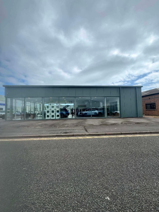 Former Suzuki Dealership to BYD Showroom – Full Exterior Spray Transformation — Weymouth, Dorset